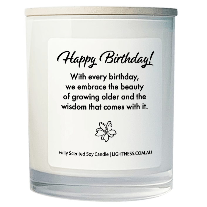 Candle in white glass jar on hand with Birthday quote - With every birthday, we embrace the beauty of growing older and the wisdom that comes with it.