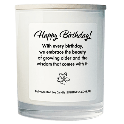 Candle in white glass jar on hand with Birthday quote - With every birthday, we embrace the beauty of growing older and the wisdom that comes with it.