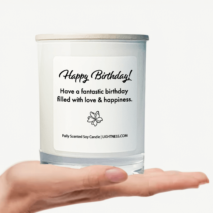 Candle in white glass jar on hand with Birthday quote - Have a fantastic birthday filled with love and happiness.