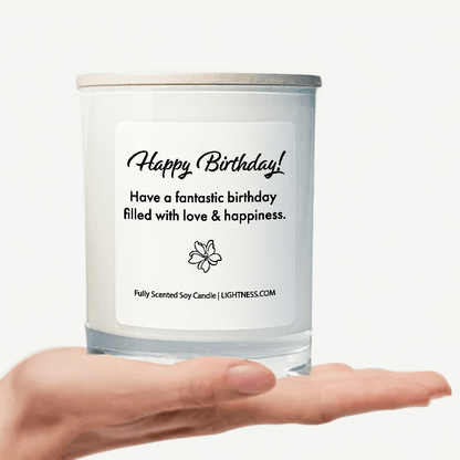 Candle in white glass jar on hand with Birthday quote - Have a fantastic birthday filled with love and happiness.