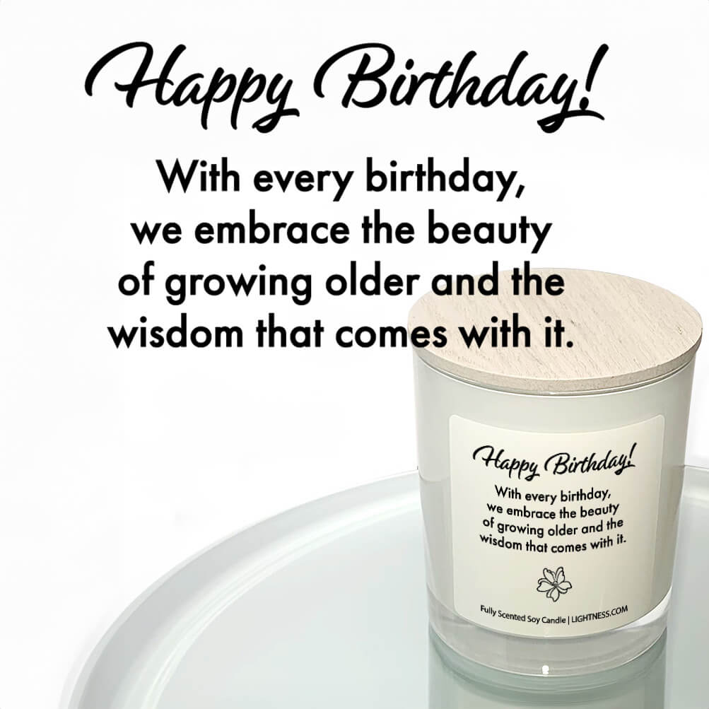 Candle in white glass jar reflected in mirror with Birthday quote - With every birthday, we embrace the beauty of growing older and the wisdom that comes with it.