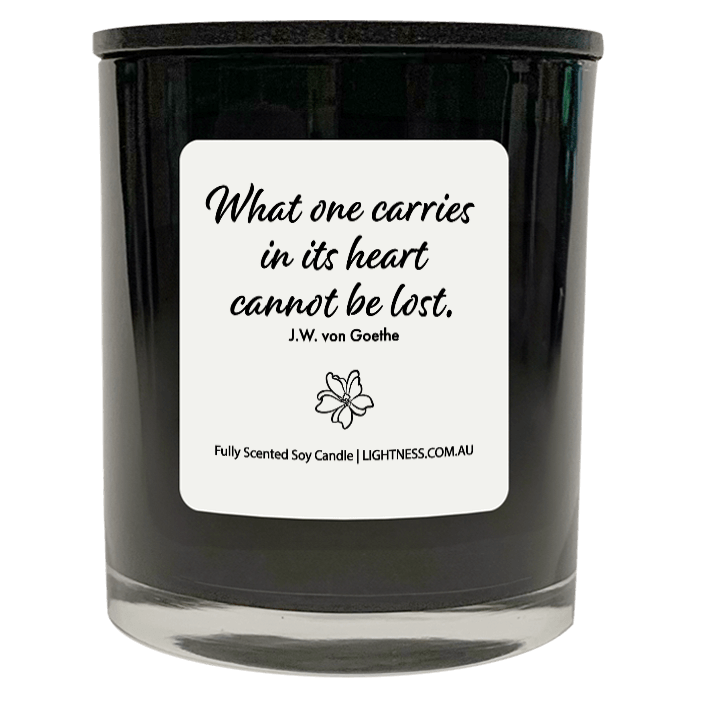 Candle in black glass jar with Condolence quote - What one carries in its heart cannot be lost.