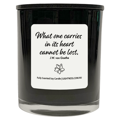 Candle in black glass jar with Condolence quote - What one carries in its heart cannot be lost.