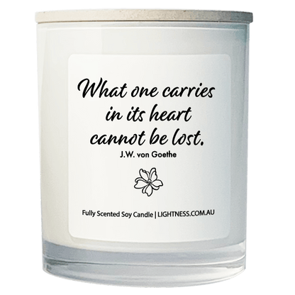 Candle in white glass jar with Condolence quote - What one carries in its heart cannot be lost.