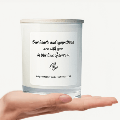 Candle in white glass jar on hand with Condolence quote - Our hearts are with you in this time of sorrow.