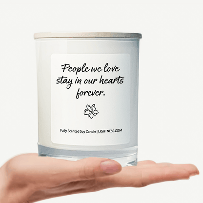 Candle in white glass jar on hand with Condolence quote - People we love stay in our hearts forever.