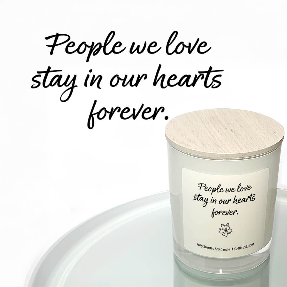 Candle in white glass jar reflected in mirror with Condolence quote - People we love stay in our hearts forever.