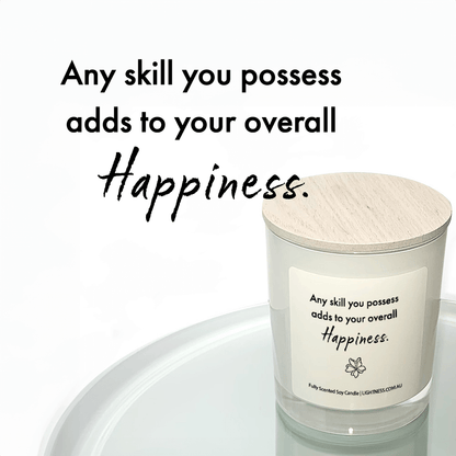 Candle in white glass jar reflected in mirror with Happiness quote - Any skill you possess adds to your overall happiness.