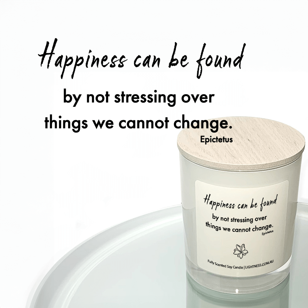 Candle in white glass jar reflected in mirror with Happiness quote - Happiness can be found by not stressing over things we cannot change.