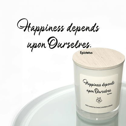 Candle in white glass jar reflected in mirror with Happiness quote - Happiness depends upon ourselves.