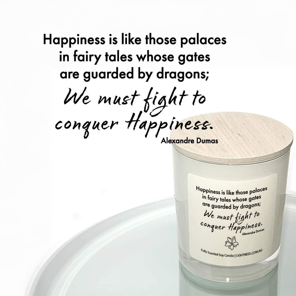 Candle in white glass jar reflected in mirror with Happiness quote - Happiness is like those palaces in fairy tales whose gates are guarded by dragons; we must fight in order to conquer it.