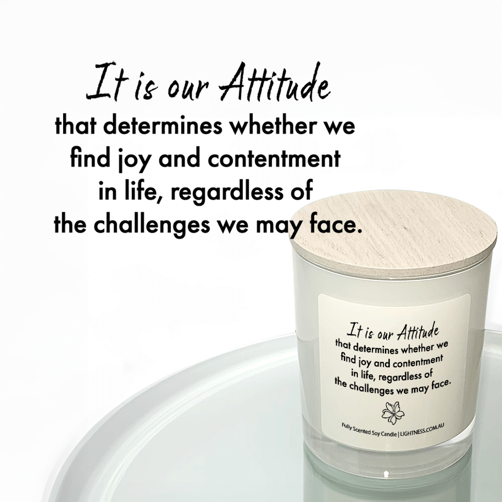 Candle in white glass jar reflected in mirror with Happiness quote - It is our attitude that determines whether we find joy and contentment in life, regardless of the challenges we may face.