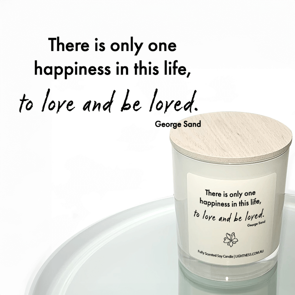 Candle in white glass jar reflected in mirror with Happiness quote - There is only one happiness in this life, to love and be loved.