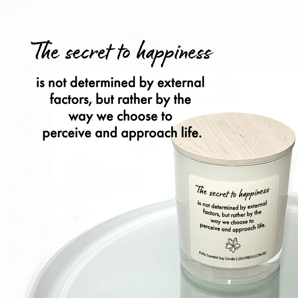 Candle in white glass jar reflected in mirror with Happiness quote - The secret to happiness is not determined by external factors, but rather by the way we choose to perceive and approach life.