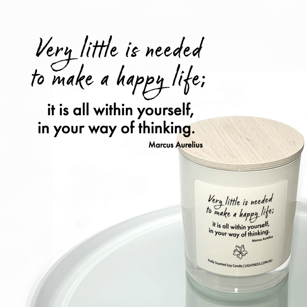 Candle in white glass jar reflected in mirror with Happiness quote - Very little is need to make a happy life; it is all within yourself, in your way of thinking.