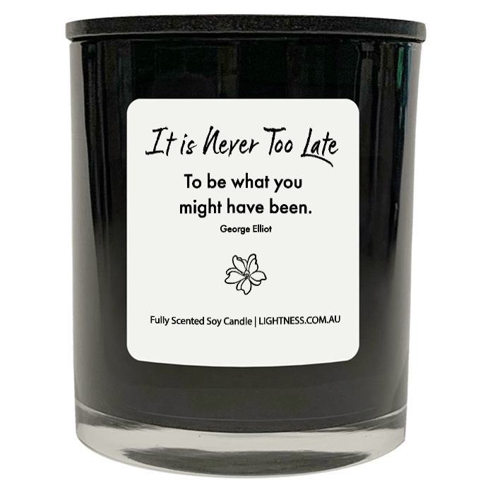 Candle in black glass jar with motivational quote - It is never too late to be what you might have been.