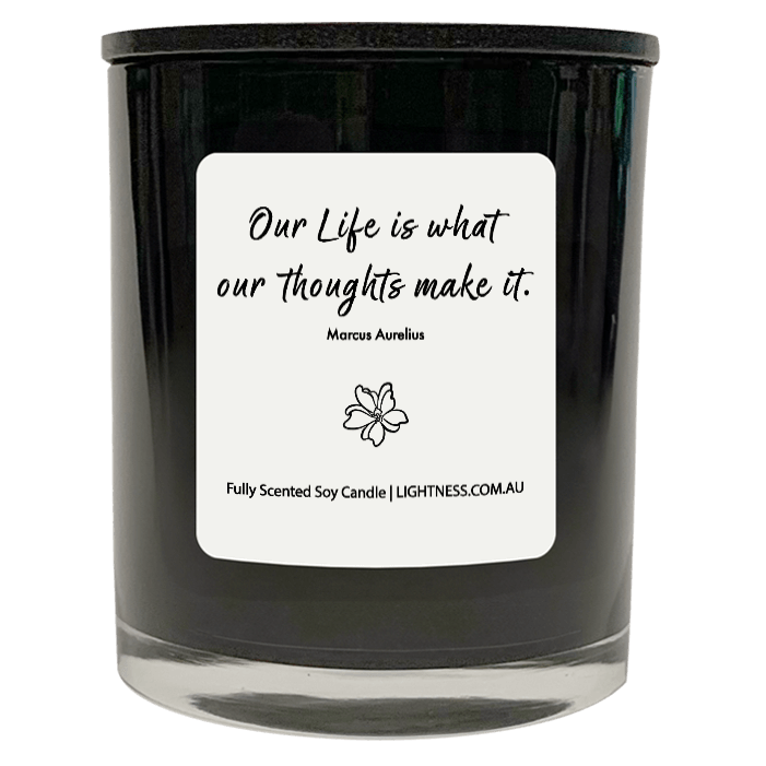 Candle in black glass jar with motivational quote - Our life is what our thoughts make it.