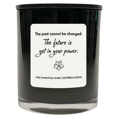 Candle in black glass jar with motivational quote - The past cannot be changed. The future is yet in your power.