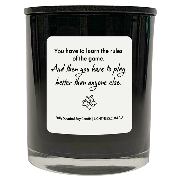 Candle in black glass jar with motivational quote - You have to learn the rules of the game. And then you have to play better than anyone else.