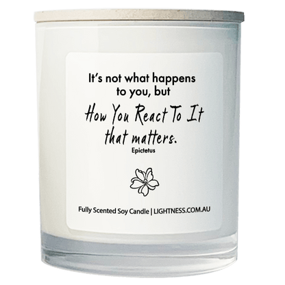 Candle in white glass jar with motivational quote - It's not what happens to you, but how you react to it that matters.