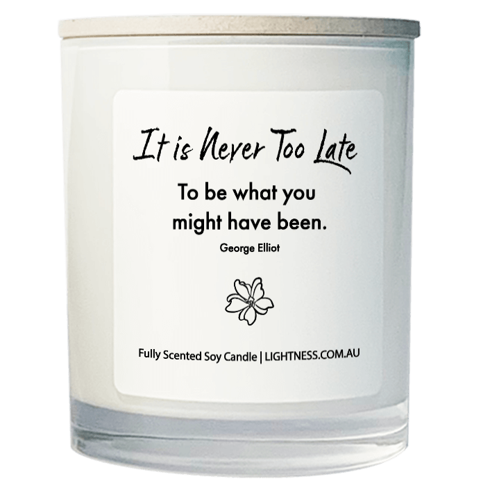 Candle in white glass jar with motivational quote - It is never too late to be what you might have been.