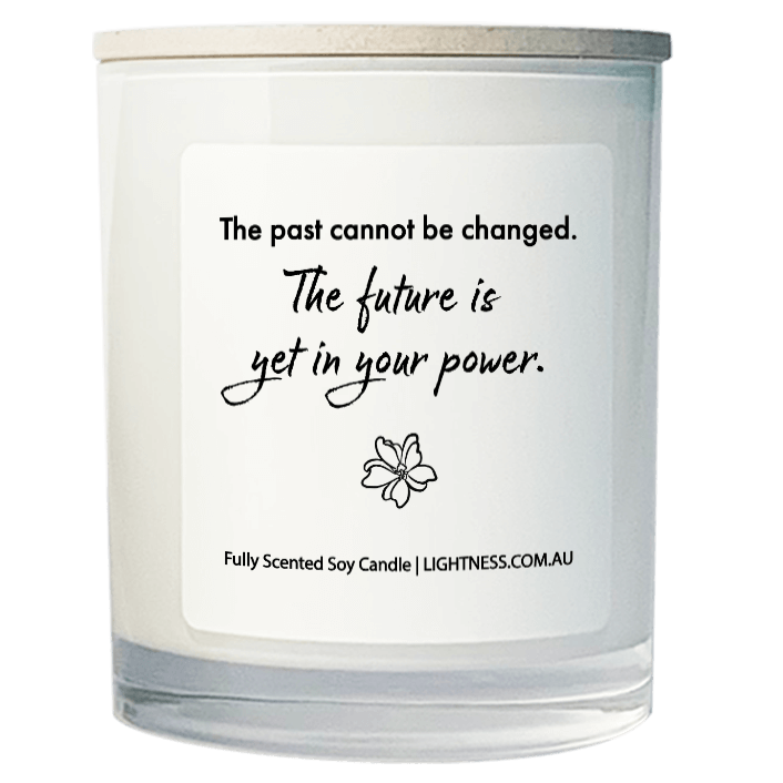 Candle in white glass jar with motivational quote - The past cannot be changed. The future is yet in your power.