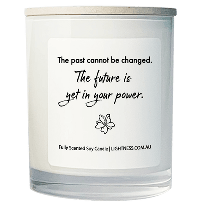 Candle in white glass jar with motivational quote - The past cannot be changed. The future is yet in your power.