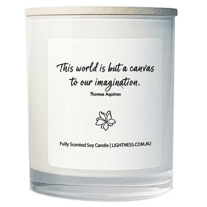 Candle in white glass jar with motivational quote - This world is but a canvas to our imagination.