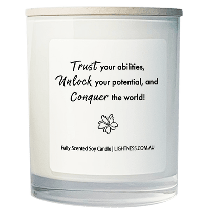 Candle in white glass jar with motivational quote - Trust your abilities, unlock your potential, and conquer the world!