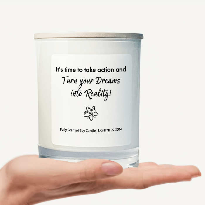 Candle in white glass jar on hand with motivational quote - t's time to take action and turn your dreams into reality!