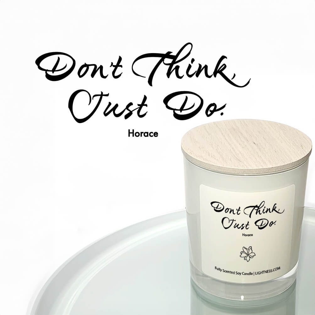 Candle in white glass jar reflected in mirror with motivational quote - Don't think, just do.