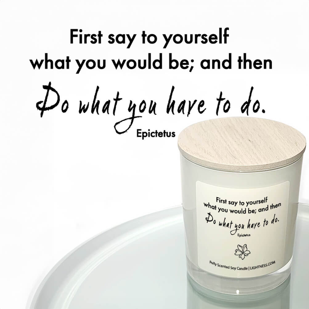 Candle in white glass jar reflected in mirror with motivational quote - First say to yourself what you would be; and then do what you have to do.