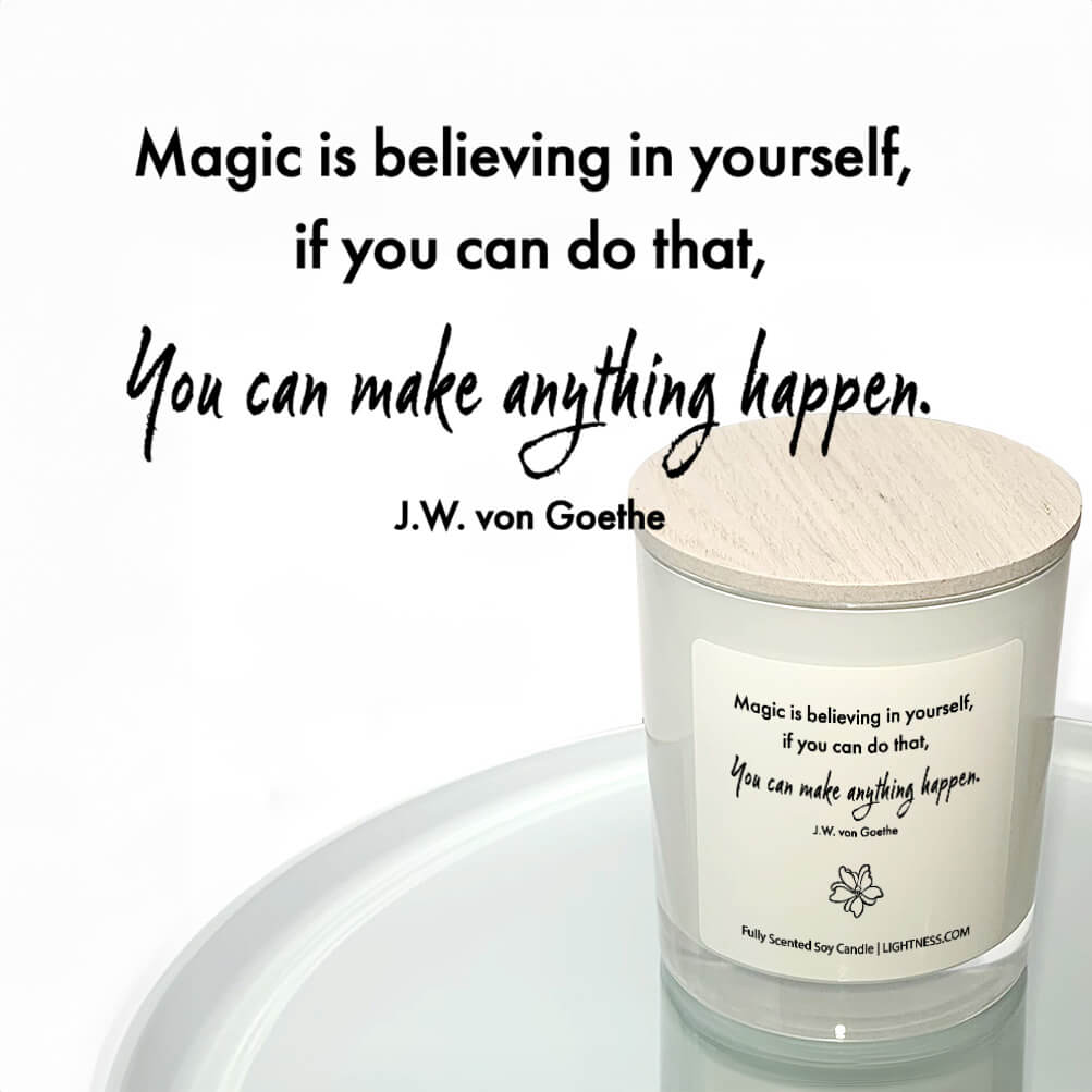 Candle in white glass jar reflected in mirror with motivational quote - Magic is believing in yourself, if you can do that, you can make anything happen.