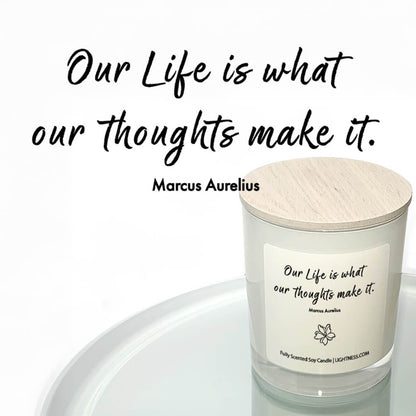 Candle in white glass jar reflected in mirror with motivational quote - Our life is what our thoughts make it.