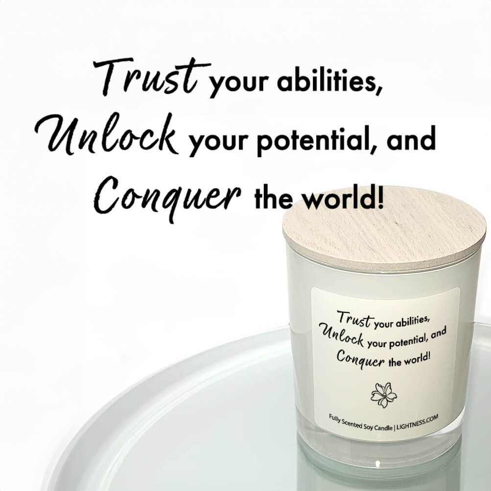 Candle in white glass jar reflected in mirror with motivational quote - Trust your abilities, unlock your potential, and conquer the world!